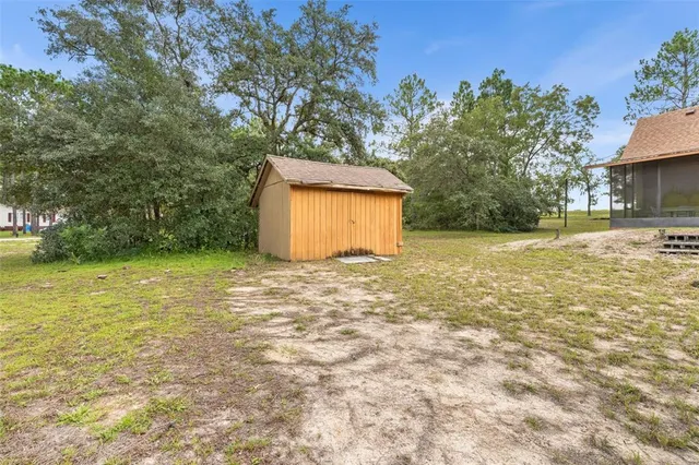 a view of a yard with a house and large trees