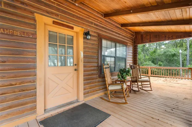 a balcony with chairs and wooden floor