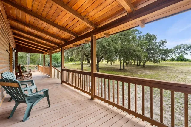 a view of a patio with a table and chairs and wooden floor