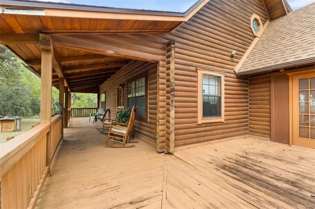 a view of backyard with deck and wooden floor