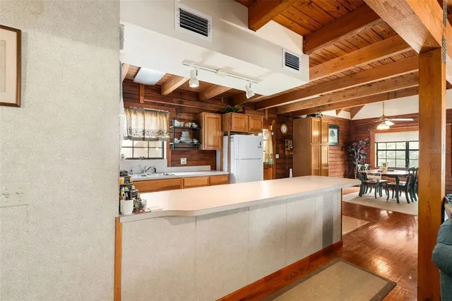 a bedroom with a bed a dresser next to a window