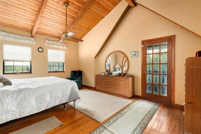 a bedroom with a bed a dresser and a shower