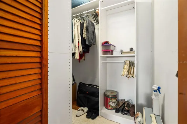 a living room with furniture a flat screen tv and a large window