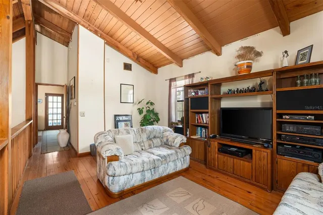 a couch sitting in a living room next to a window