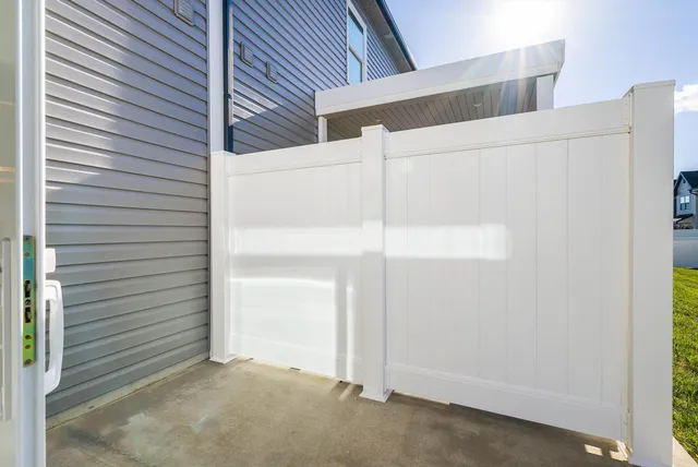 a kitchen with kitchen island granite countertop stainless steel appliances a refrigerator a sink a stove cabinets and wooden floor