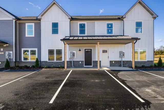 a kitchen with stainless steel appliances granite countertop a sink a stove and a wooden floor