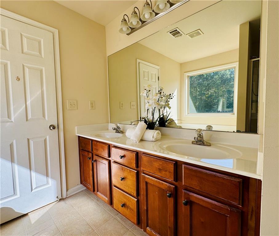 164 Thorncrest Court Tucker, GA 30084 - Photo 18 of 26 a bathroom with a double vanity sink and a mirror
