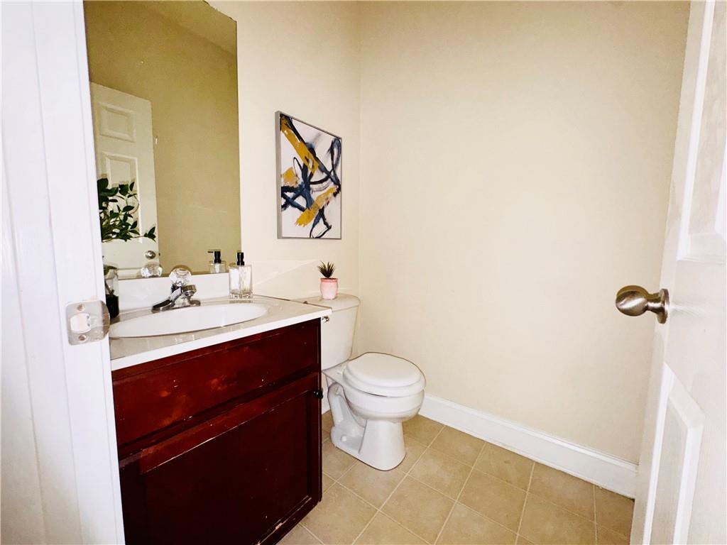 164 Thorncrest Court Tucker, GA 30084 - Photo 24 of 26 a bathroom with a sink mirror vanity and toilet