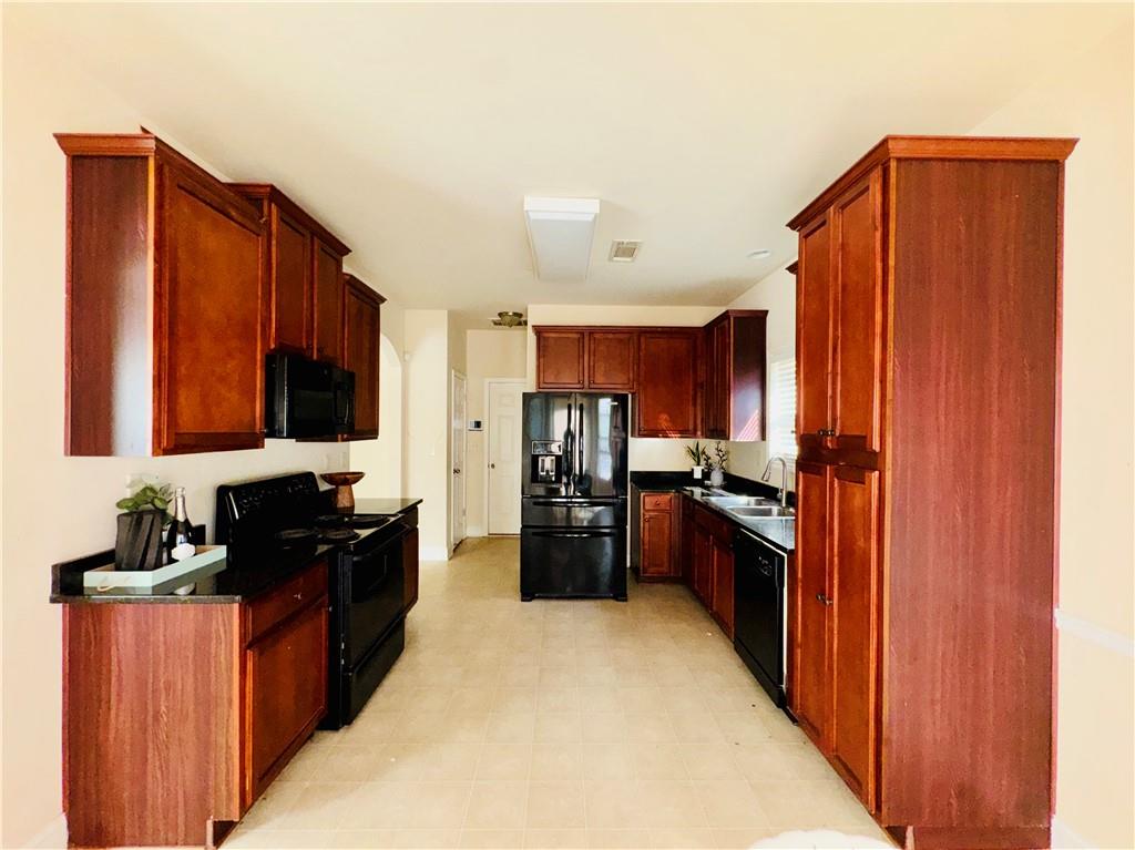 164 Thorncrest Court Tucker, GA 30084 - Photo 8 of 26 a kitchen with a refrigerator stove and a sink