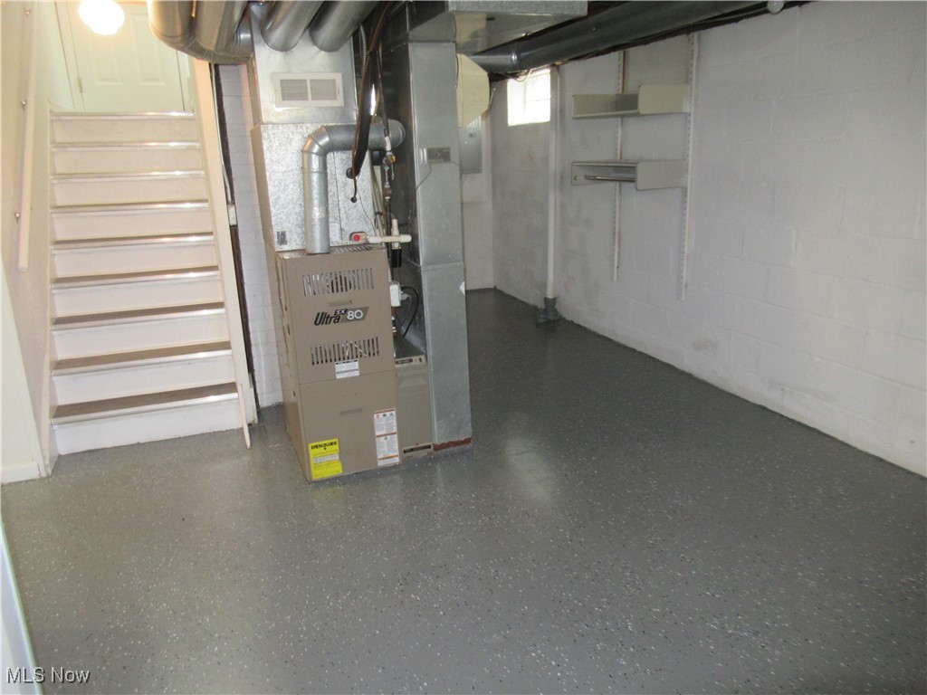 1397 Sunset Road Cleveland, OH 44124 - Photo 27 of 32 Basement featuring stairway, concrete block wall, and heating unit