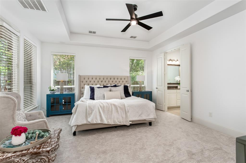 846 Deerfield Road Allen, TX 75013 - Photo 18 of 40 Tray ceiling with a ceiling fan, light-colored carpeting, multiple windows with blinds, and white double doors leading to a bathroom