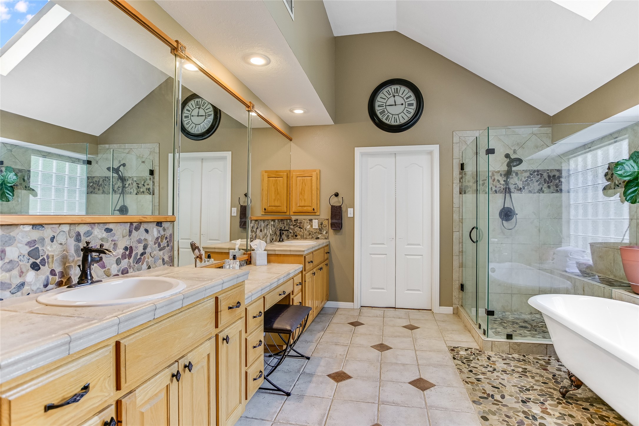 741 Knobbs Road McDade, TX 78650 - Photo 16 of 38 Dual vanities and a spacious glass-enclosed shower create a luxurious, functional bath retreat.