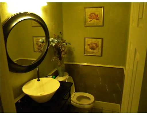 a bathroom with a toilet and a mirror