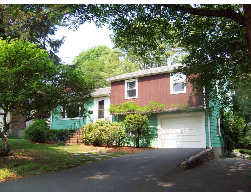 11 Puritan Road Arlington, MA 02476 - Photo 1 of 7 a front view of a house with a yard and a garage
