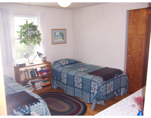 11 Puritan Road Arlington, MA 02476 - Photo 3 of 7 a bedroom with a bed window and a potted plant
