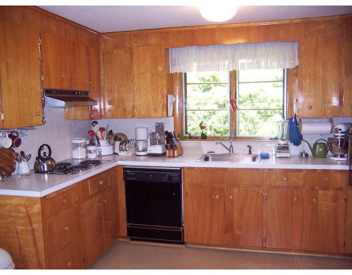 11 Puritan Road Arlington, MA 02476 - Photo 5 of 7 a kitchen with stainless steel appliances granite countertop a sink a stove a counter space and cabinets