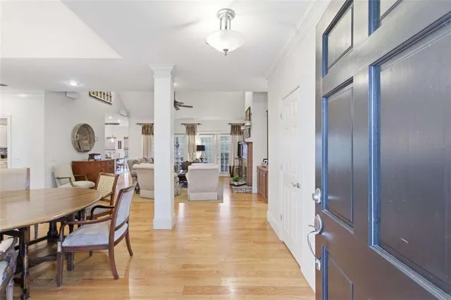 an open kitchen and dining room with wooden floor