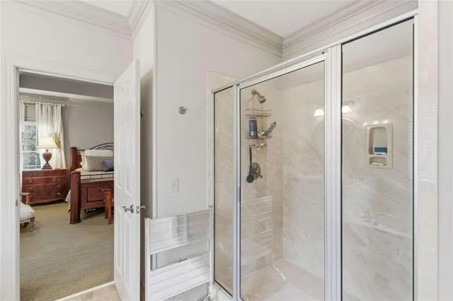a bathroom with a glass shower door and a mirror