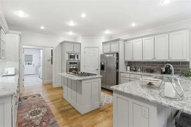 a kitchen with refrigerator and cabinets