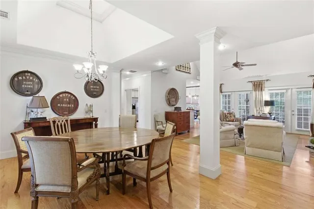 a view of a dining room and livingroom with furniture wooden floor and a clock