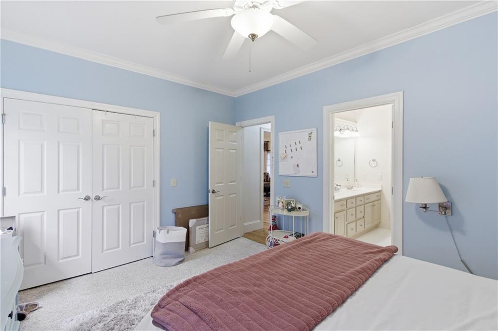 1038 Farmhouse Road Gainesville, GA 30506 - Photo 24 of 51 a bedroom with a bed and a chandelier