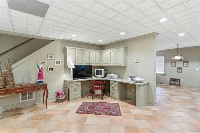 a living room with furniture kitchen view and a large window