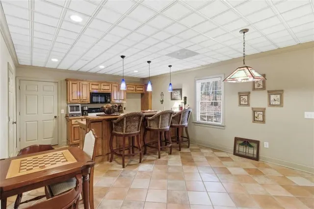 a living room with furniture a pool table and a table