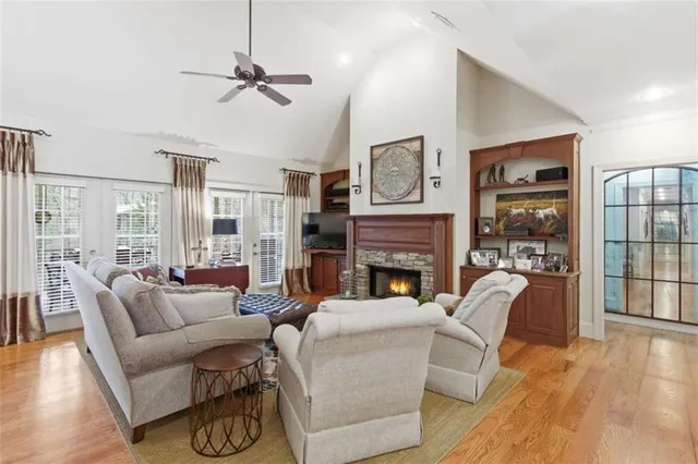 a living room with furniture a fireplace and a table