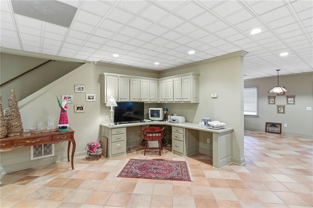 1038 Farmhouse Road Gainesville, GA 30506 - Photo 41 of 51 a kitchen with stainless steel appliances kitchen island granite countertop a sink and cabinets