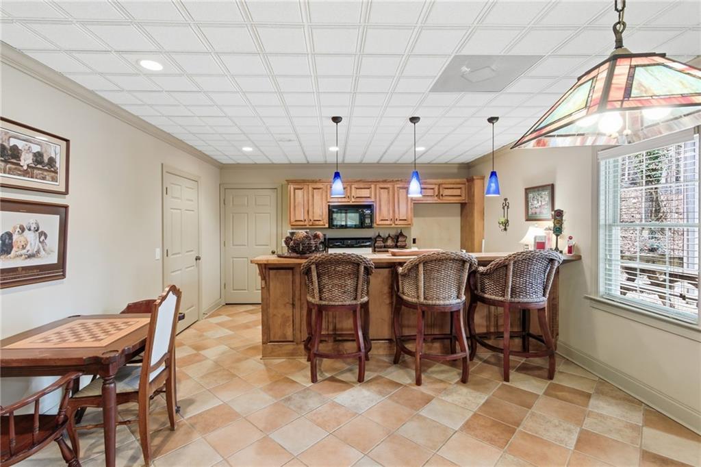 1038 Farmhouse Road Gainesville, GA 30506 - Photo 45 of 51 a view of a dining room with furniture and a chandelier