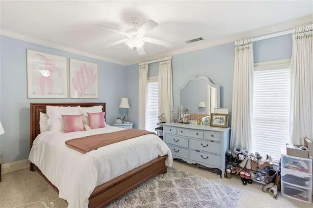 a bedroom with a bed a chandelier and a mirror