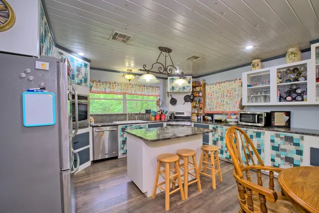 a kitchen with stainless steel appliances granite countertop a stove and a sink