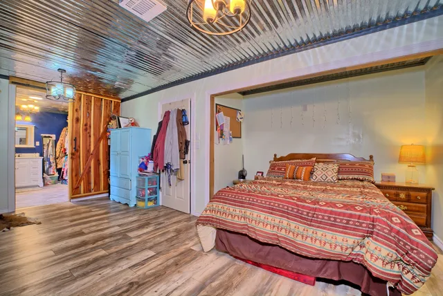 a bedroom with bed and a wooden floor