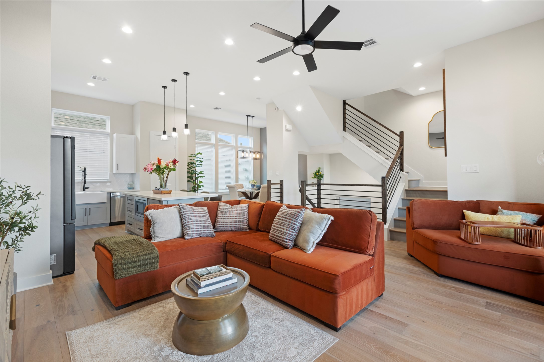 a living room with furniture and a ceiling fan