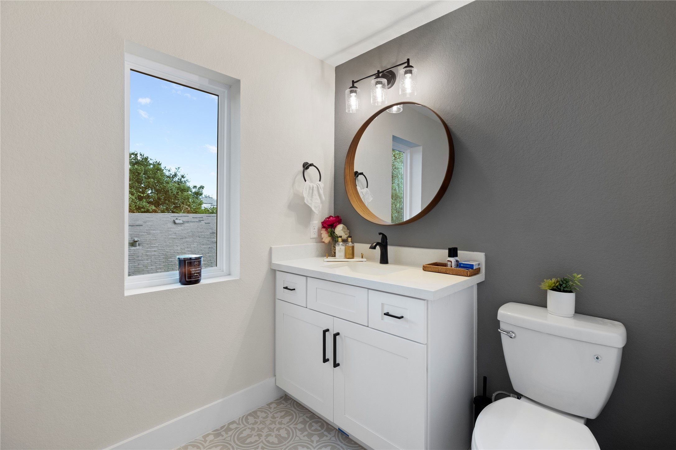 1410 Milby Street, Unit C Houston, TX 77003 - Photo 22 of 28 a bathroom with a toilet a sink and a mirror