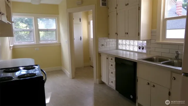 a kitchen with a sink and cabinets