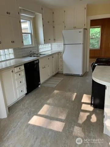 a kitchen with a sink cabinets and window