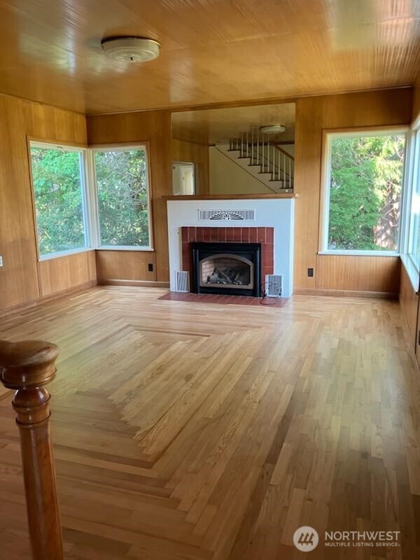 1555 Swartout Road Manson, WA 98831 - Photo 19 of 40 a view of empty room with wooden floor and fireplace
