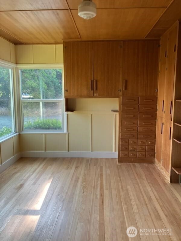 1555 Swartout Road Manson, WA 98831 - Photo 20 of 40 an empty room with wooden floor and windows