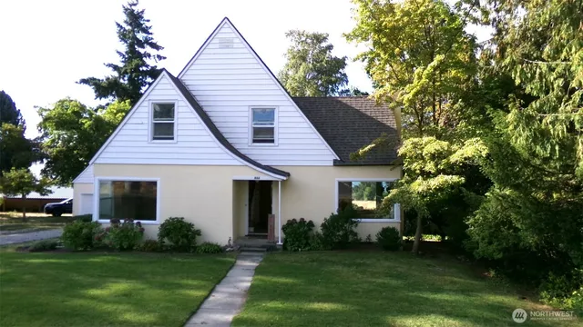 a front view of a house with a garden