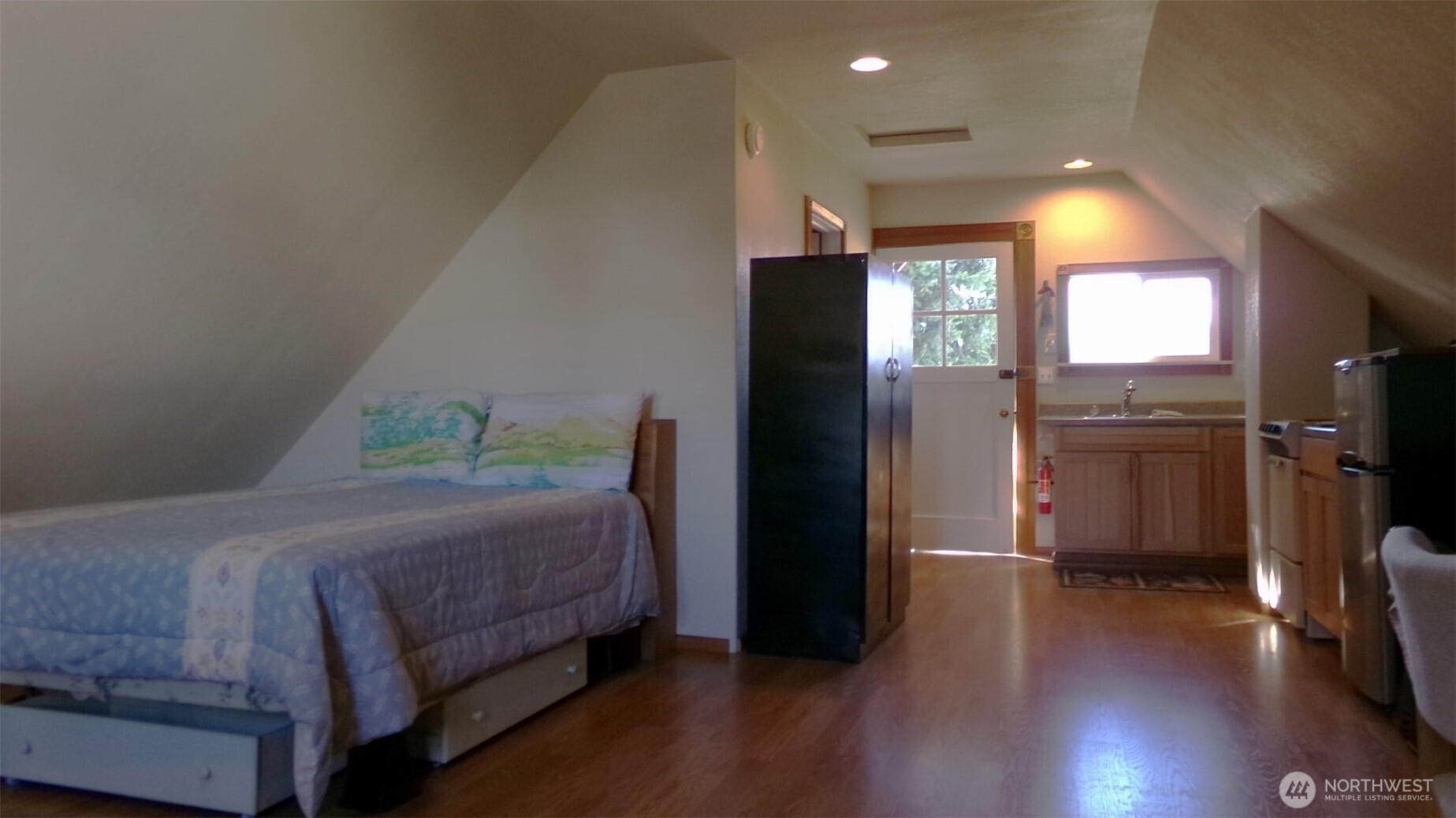 1555 Swartout Road Manson, WA 98831 - Photo 32 of 40 a bedroom with a bed and wooden floor
