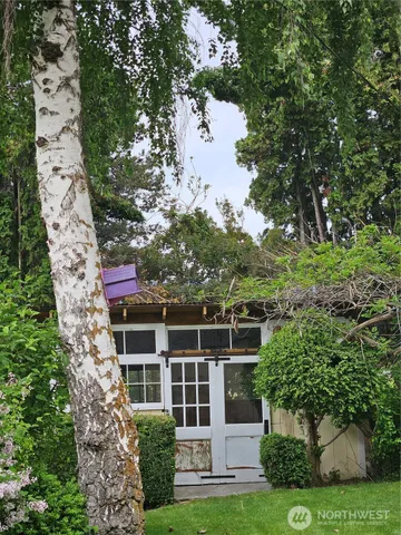 a view of a house with yard and sitting area