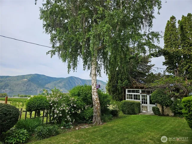 a view of a house with a yard and a garden