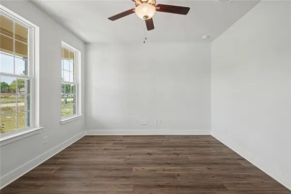 a view of kitchen with kitchen island wooden floor appliances and cabinets