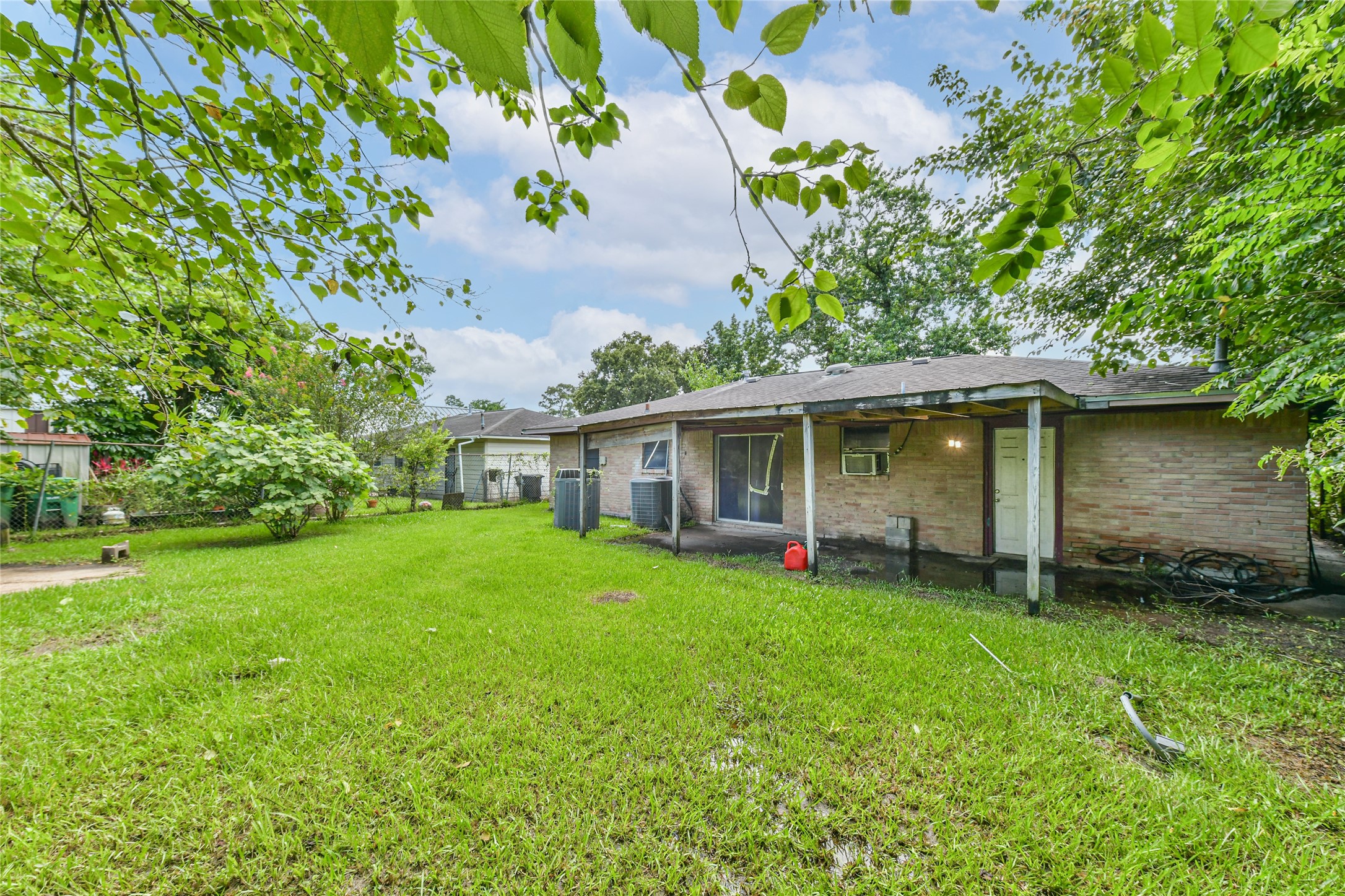 10438 Caxton Street Houston, TX 77016 - Photo 22 of 24 a view of a house with a yard and sitting area