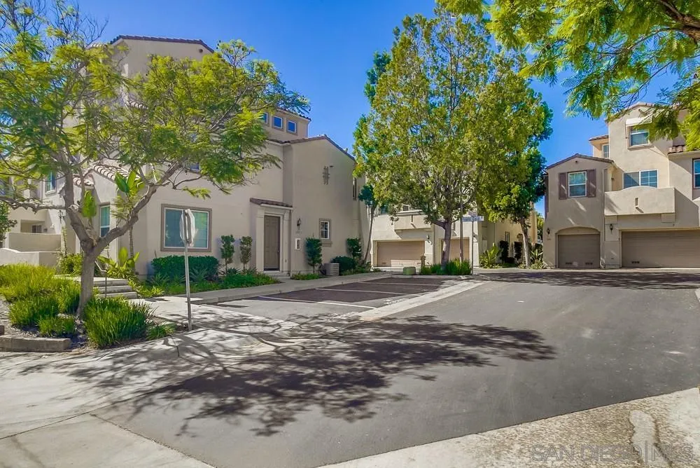 1298 Fools Gold Way, Unit 4 Chula Vista, CA 91913 - Photo 36 of 38 a front view of a house with a yard and garage