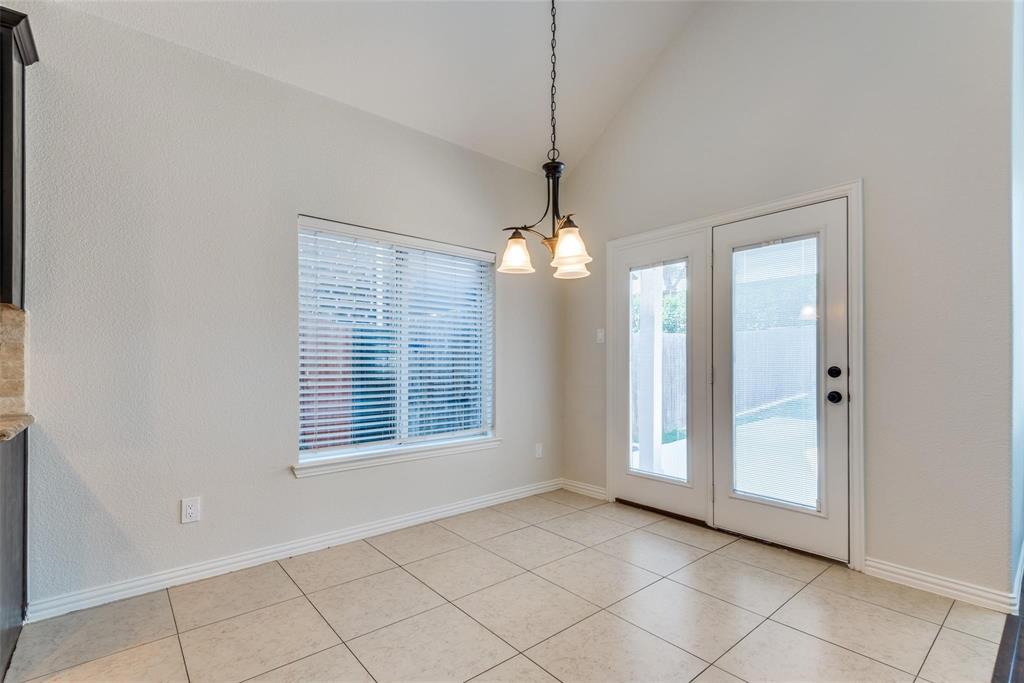 2344 Ranchview Drive Little Elm, TX 75068 - Photo 11 of 24 Vaulted ceiling dining area featuring tile flooring, a window with blinds, and double-pane French doors