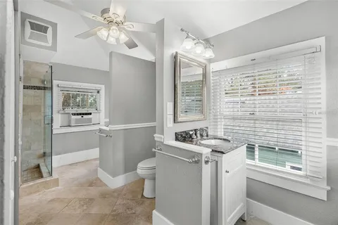 a bathroom with a sink a toilet a mirror and a tub