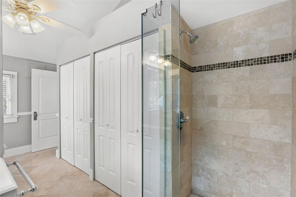 1003 East Jackson Street Orlando, FL 32801 - Photo 12 of 27 a bathroom with a glass shower door