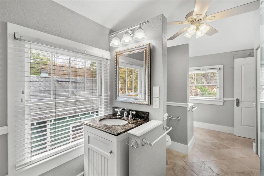 1003 East Jackson Street Orlando, FL 32801 - Photo 13 of 27 a bathroom with a sink and a mirror